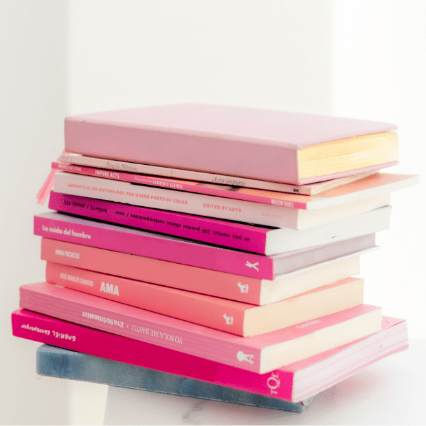 pile of pink books. Resources for business success, personal growth, and self-confidence.
