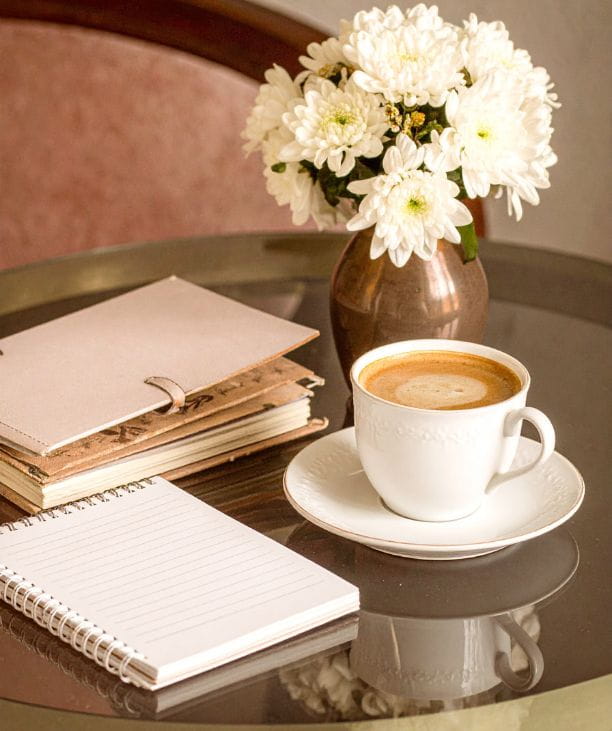How to Build Customer Loyalty in a Small Business (notebook and coffee flat lay)- Sarah Connelly - Strategic partner for founder-led fashion & lifestyle brands | Fractional COO, Mentor & Wing-woman