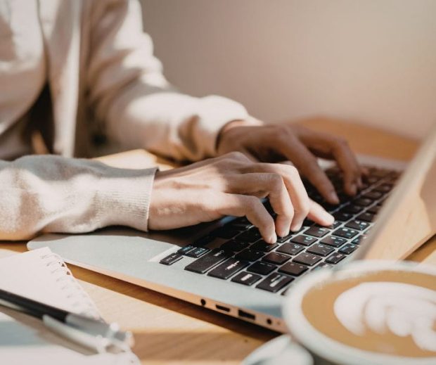 Small business owner writing weekly customer email newsletter for boutique loyalty.
