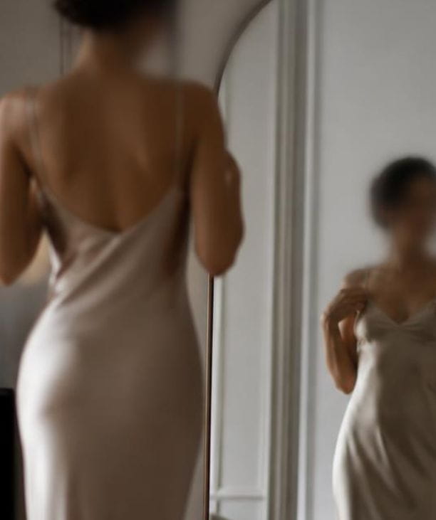 finding the right lingerie fit — woman checking reflection